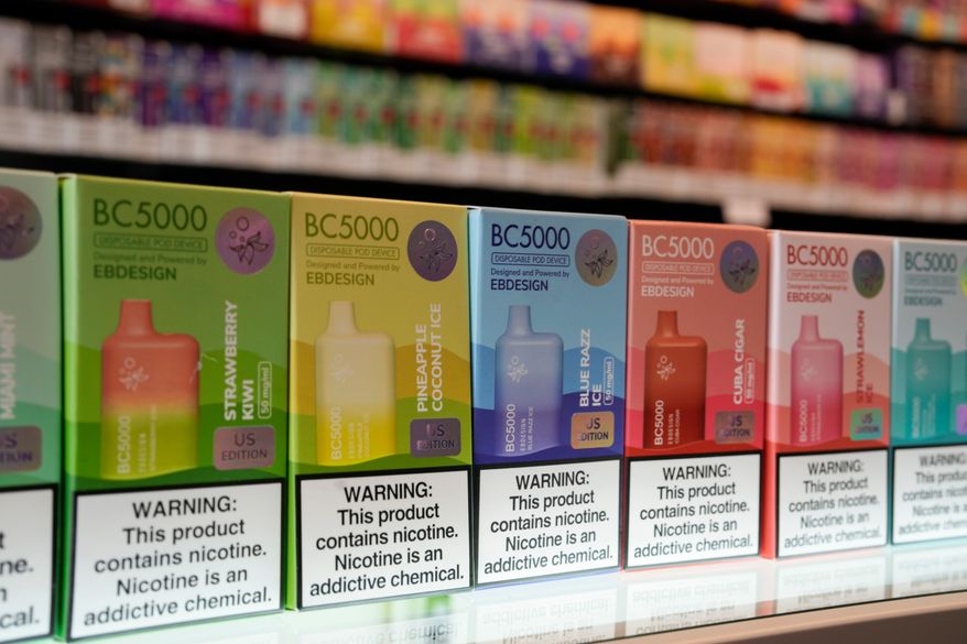 Varieties of disposable flavored electronic cigarette devices manufactured by EB Design, formerly known as Elf Bar, are displayed at a store in Pinecrest, Fla., June 26, 2023. (AP Photo/Rebecca Blackwell, File)