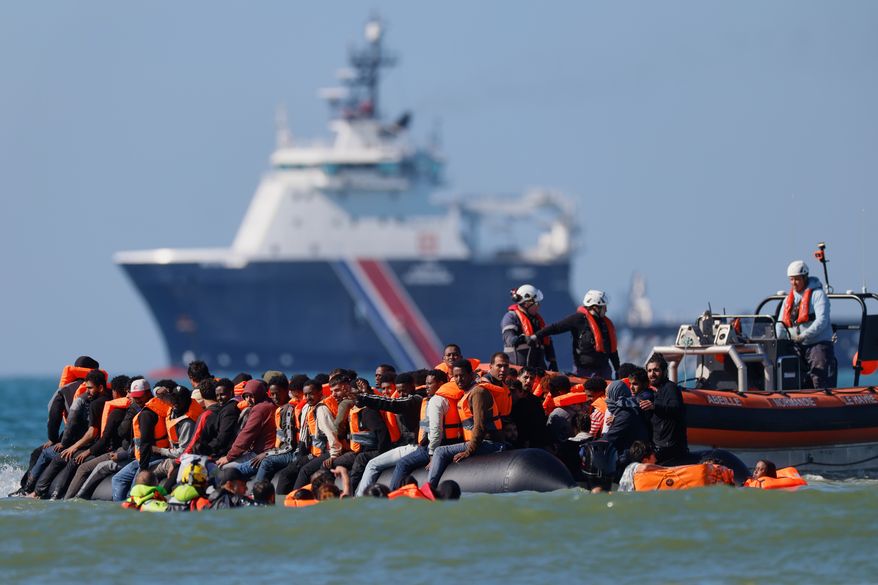 FILE - A group of migrants try to cross the channel from France to Britain on a dinghy boat, in Hardelot, northern France, Wednesday, Sept. 23, 2026. (AP Photo/Jean-Francois Badias, File)