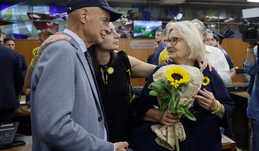 Paola Deffendi, Giulio Regeni's mother, right, her husband Claudio and their daughter Irene, center, embrace after the verdict of a Rome court which convicted three of four Egyptian security officials to 10 years in prison for the abduction and murder of Giulio in Cairo in 2016, in Rome, Monday, Sept. 28, 2026. (Cecilia Fabiano/LaPresse via AP)
