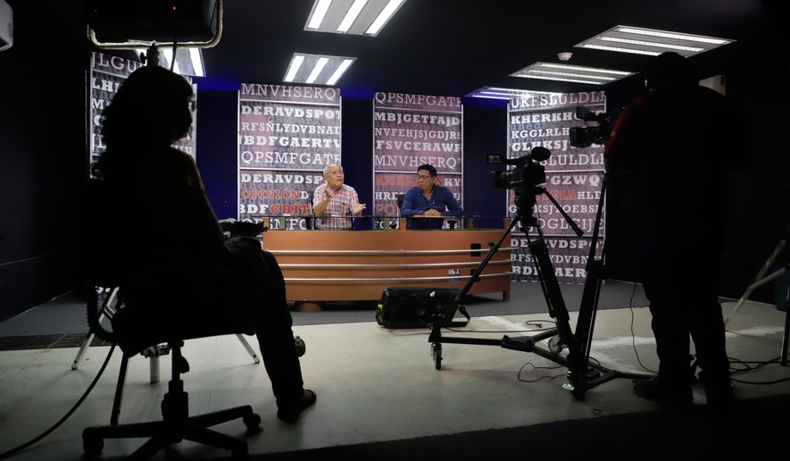 Jorge Luis González, former director of the independent newspaper Tribuna, left, and journalist Lorenzo Chim Caamal, host the program Expediente in Campeche, Mexico, Thursday, Sept. 17, 2026. (AP Photo/Martin Zetina)