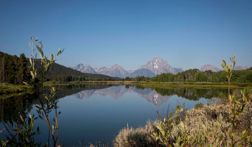 FILE - The Teton mountains reflect on Oxbow Bend in Grand Teton National Park in Moran, Wyo., Aug. 22, 2025. (AP Photo/Amber Baesler, File)