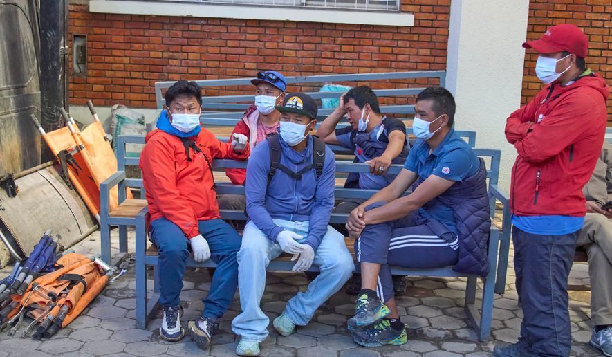 Family members and friends of Nepali climbers gather as the bodies of Nepali climbers recovered after an avalanche on Mount Himlung lie at the morgue of a hospital in Kathmandu, Nepal, Monday, Sept. 28, 2026. (AP Photo/Niranjan Shrestha)