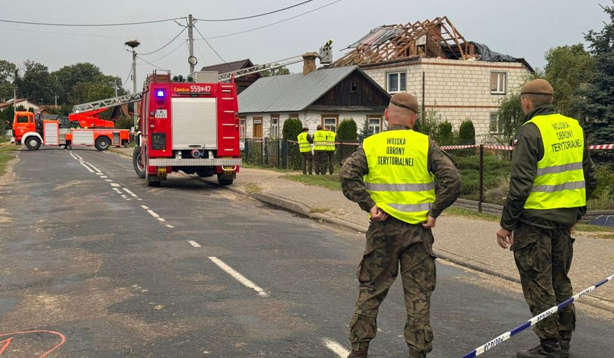 FILE - Firefighters and territorial defence officers stand close to the destroyed roof of a house, after Russian drones violated Polish airspace during an attack on Ukraine, in Wyryki near Lublin, Poland, Sept. 11, 2025. (AP Photo/Rafal Niedzielski, File)