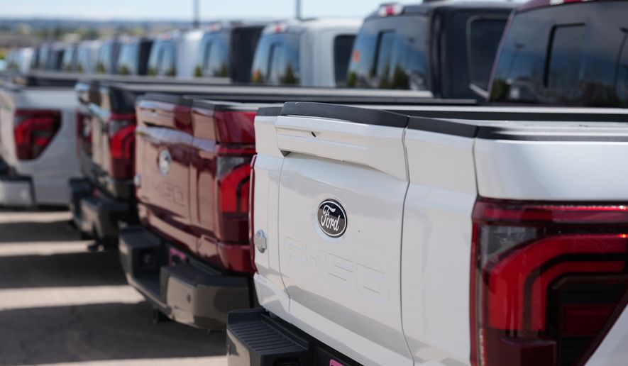 Unsold 2026 F-150 pickup trucks sit in a long line outside a Ford dealership on April 12, 2026, in Centennial, Colo. (AP Photo/David Zalubowski, File)
