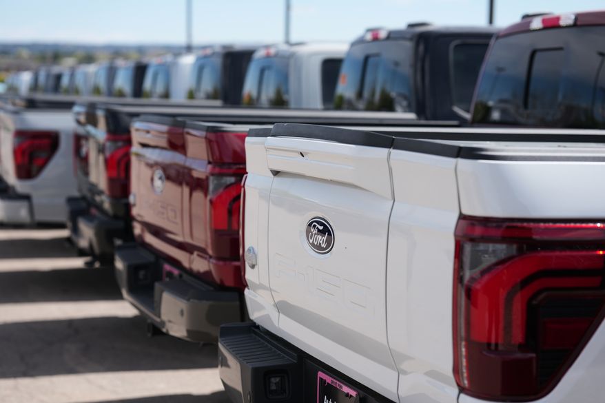 Unsold 2026 F-150 pickup trucks sit in a long line outside a Ford dealership on April 12, 2026, in Centennial, Colo. (AP Photo/David Zalubowski, File)