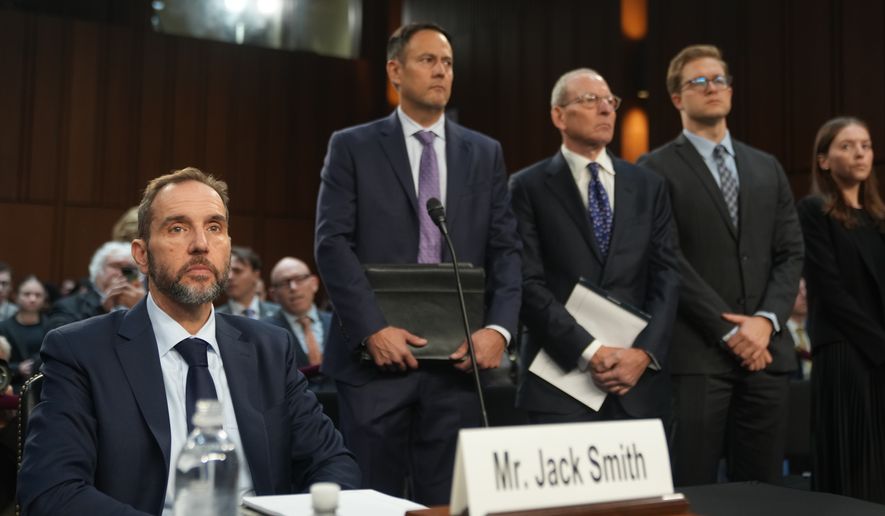 Former Justice Department special counsel Jack Smith, seated left, and attorneys, arrive before the Senate Judiciary Committee at the Capitol, Tuesday, Sept. 29, 2026, in Washington. (AP Photo/Allison Robbert)