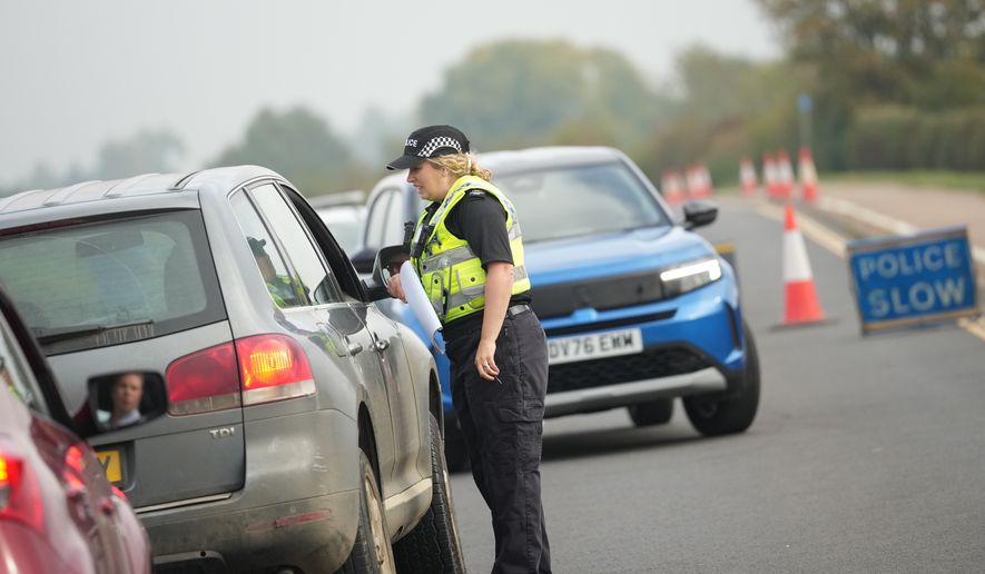 Police officers stand at a checkpoint near RAF Fairford air base, in Fairford, England Tuesday, Sept. 29, 2026. (AP Photo/Alastair Grant)