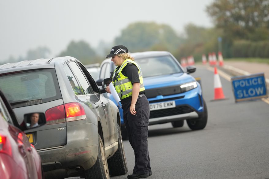 Police officers stand at a checkpoint near RAF Fairford air base, in Fairford, England Tuesday, Sept. 29, 2026. (AP Photo/Alastair Grant)