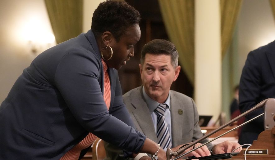 Assemblymember LaShae Sharp-Collins, left, talks with Assemblymember Christopher Ward during an Assembly session at the Capitol, Monday, Aug. 31, 2026, in Sacramento, Calif. (AP Photo/Jeff Chiu)