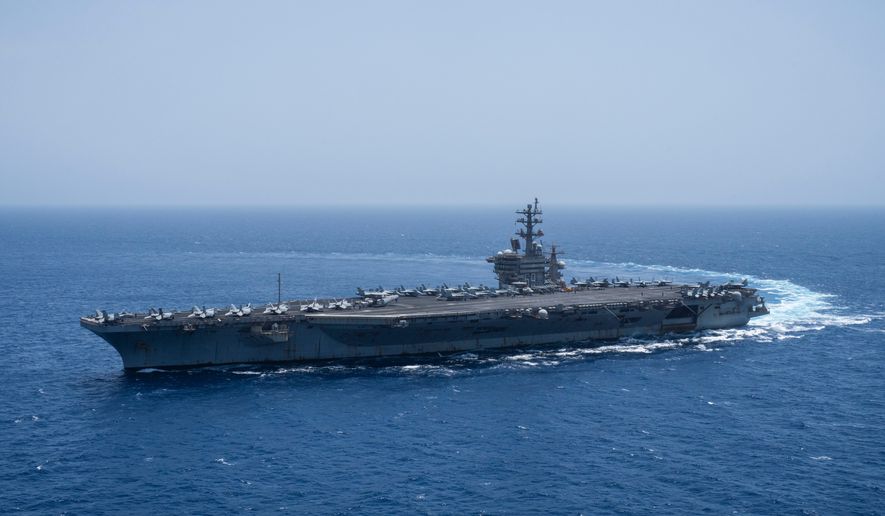 The USS aircraft carrier Dwight D. Eisenhower, also known as 'IKE', sails in the Red Sea, June 12, 2024. (AP Photo/Bernat Armangue, File)