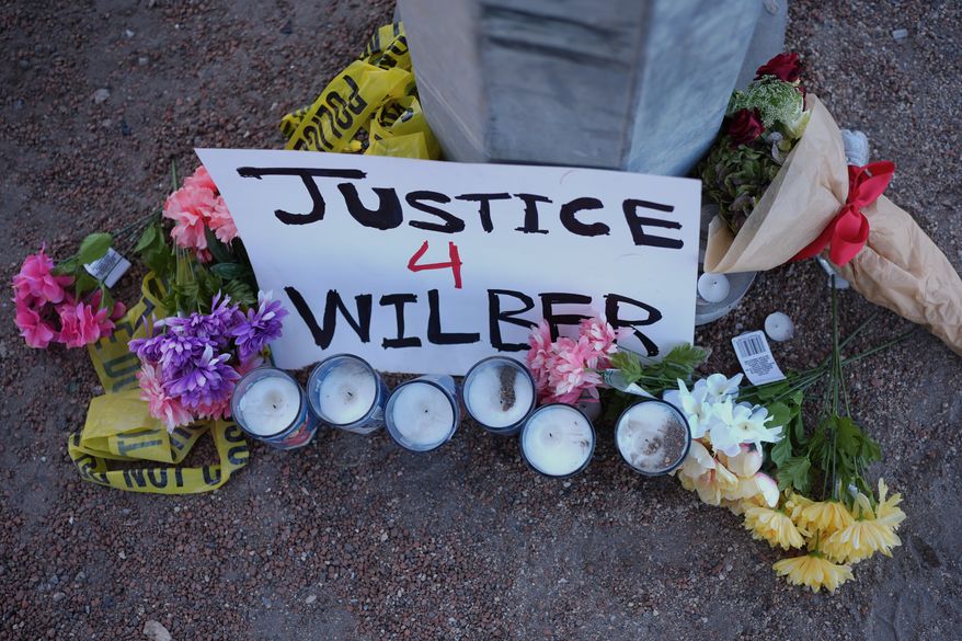 Flowers and candles are placed near the site where a Venezuelan man was shot in his vehicle by an ICE officer in Austin, Texas, Monday, Sept. 21, 2026. (AP Photo/Eric Gay)