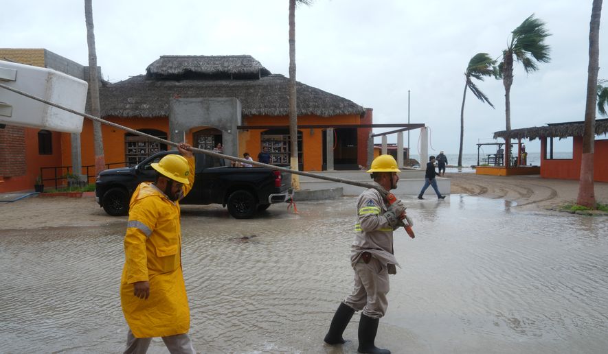 Workers pull a boat to shore as Hurricane Polo approaches Puerto San Carlos, Baja California Sur state, Mexico, Monday, Sept. 28, 2026. (AP Photo/Eduardo Verdugo)