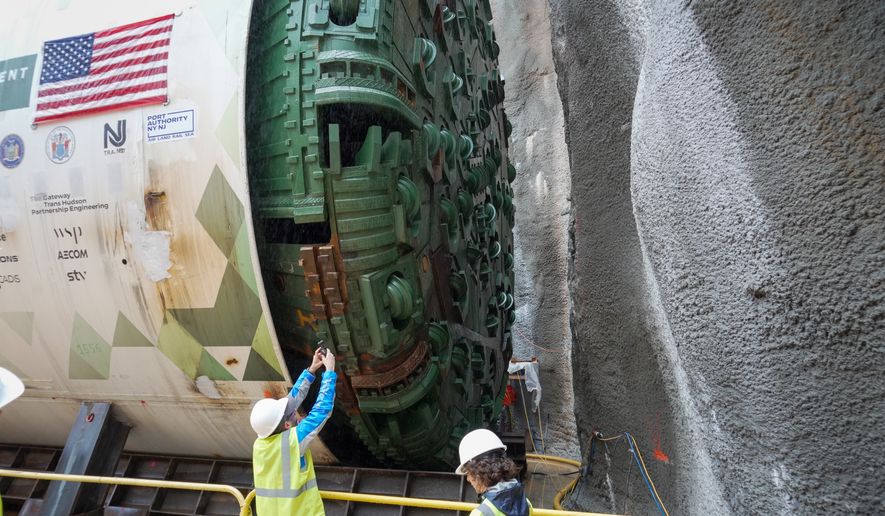 Officials gather between two tunnel-boring machines in North Bergen, N.J., on Monday, Sept. 28, 2026, during a ceremony for the construction of a new passenger rail tunnel linking New Jersey and Manhattan beneath the Hudson River. (AP Photo/Ted Shaffrey)