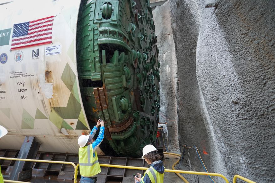 Officials gather between two tunnel-boring machines in North Bergen, N.J., on Monday, Sept. 28, 2026, during a ceremony for the construction of a new passenger rail tunnel linking New Jersey and Manhattan beneath the Hudson River. (AP Photo/Ted Shaffrey)