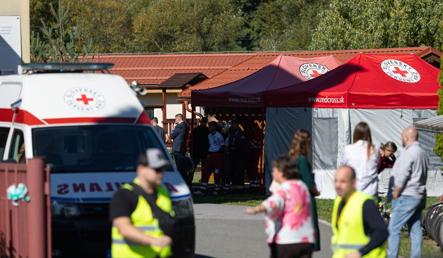 Slovak Red Cross members work at a site following a stabbing attack by a pupil at the primary school in Staskov, Slovakia, Tuesday, Sept. 29, 2026. (Daniel Stehlik/TASR via AP)