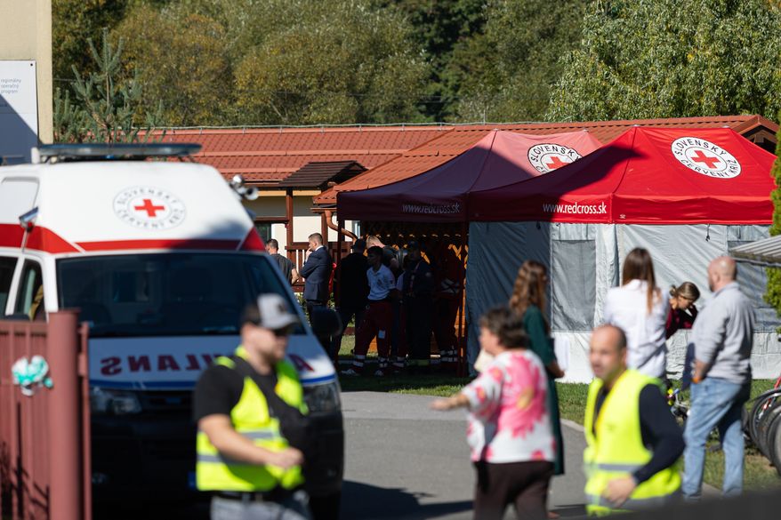 Slovak Red Cross members work at a site following a stabbing attack by a pupil at the primary school in Staskov, Slovakia, Tuesday, Sept. 29, 2026. (Daniel Stehlik/TASR via AP)