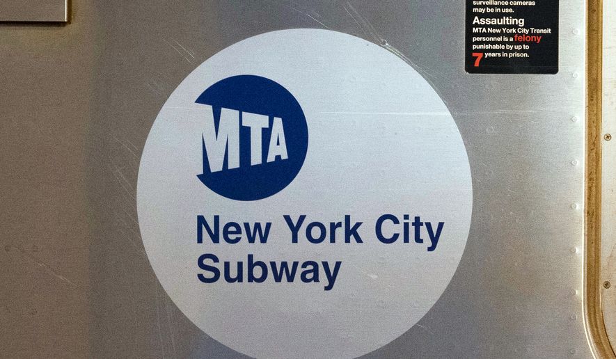 The MTA logo is seen on the side of a New York City subway car in New York on April 23, 2020. (AP Photo/Mark Lennihan) **FILE**