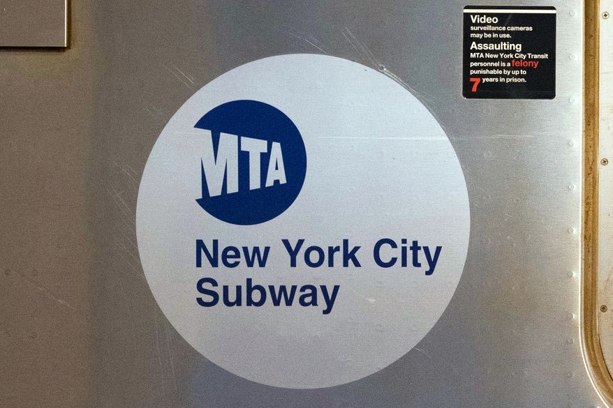 The MTA logo is seen on the side of a New York City subway car in New York on April 23, 2020. (AP Photo/Mark Lennihan) **FILE**