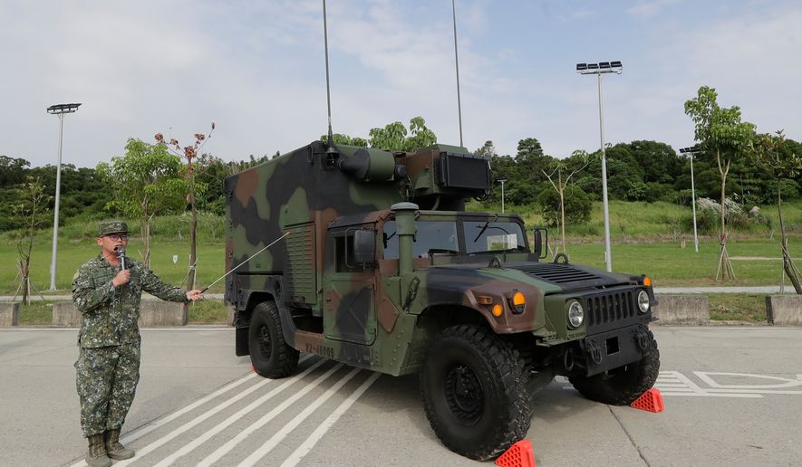 A soldier briefing a specialized HIMARS (M142 High Mobility Artillery Rocket System) command and control vehicle based on an M152A1 HMMWV during a media event in Tainan, Southern Taiwan, Tuesday, Sept. 22, 2026. (AP Photo/Chiang Ying-ying)