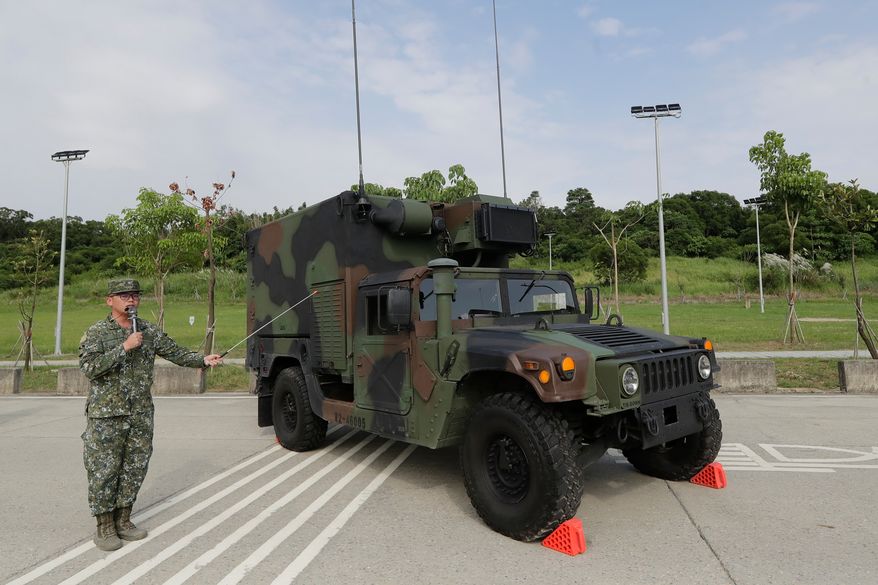 A soldier briefing a specialized HIMARS (M142 High Mobility Artillery Rocket System) command and control vehicle based on an M152A1 HMMWV during a media event in Tainan, Southern Taiwan, Tuesday, Sept. 22, 2026. (AP Photo/Chiang Ying-ying)