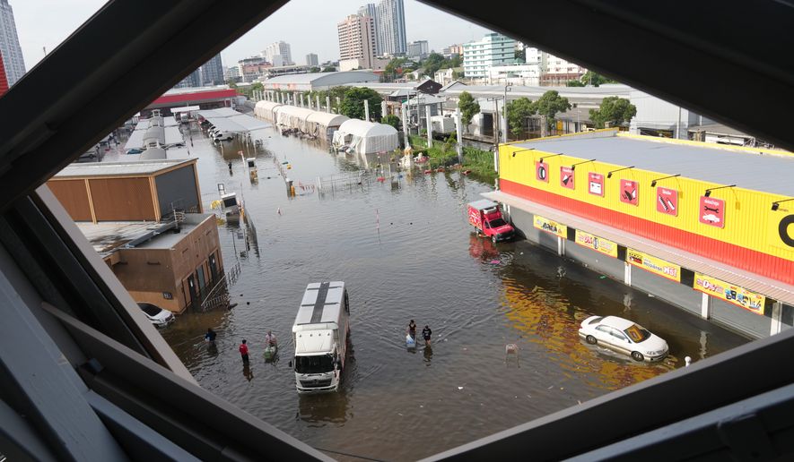 Streets are flooded after heavy rain in Bangkok, Thailand, Tuesday, Sept. 29, 2026. (AP Photo/Sakchai Lalit)