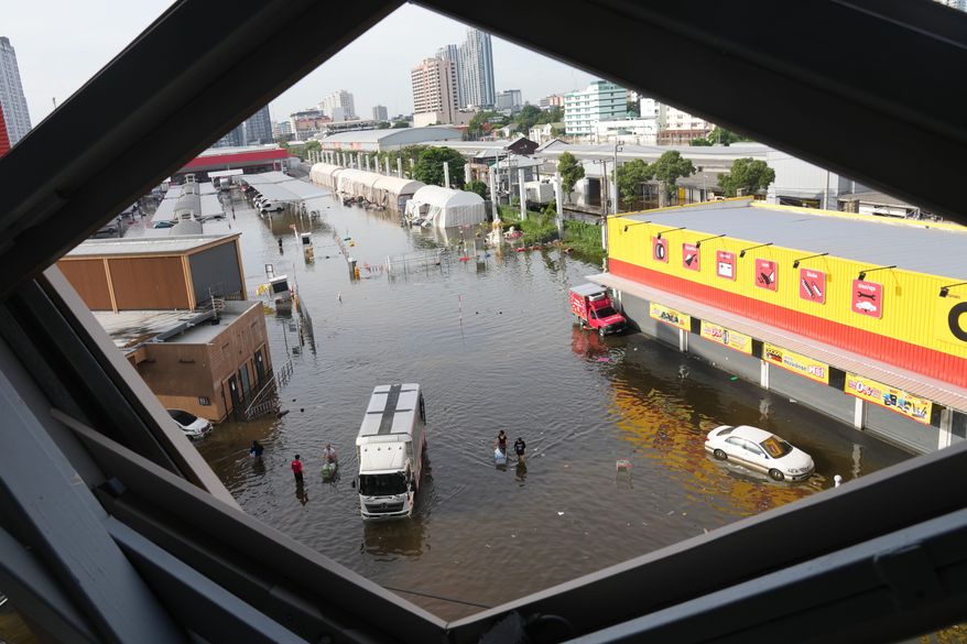 Streets are flooded after heavy rain in Bangkok, Thailand, Tuesday, Sept. 29, 2026. (AP Photo/Sakchai Lalit)