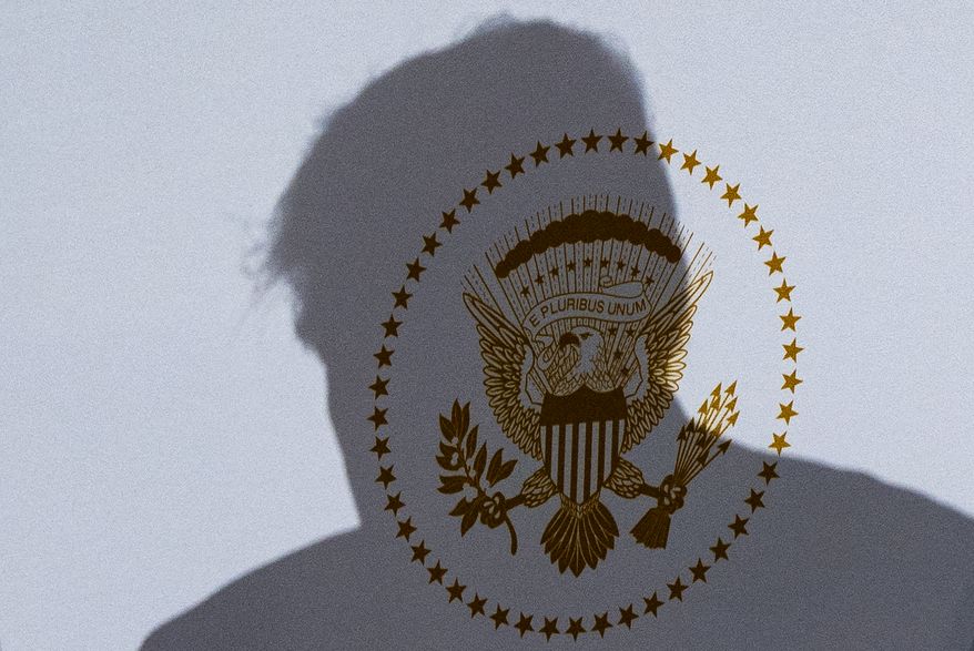 The shadow of President Donald Trump falls on the Presidential Seal as he speaks at the Andrew W. Mellon Auditorium, Tuesday, Sept. 29, 2026, in Washington. (AP Photo/Alex Brandon)