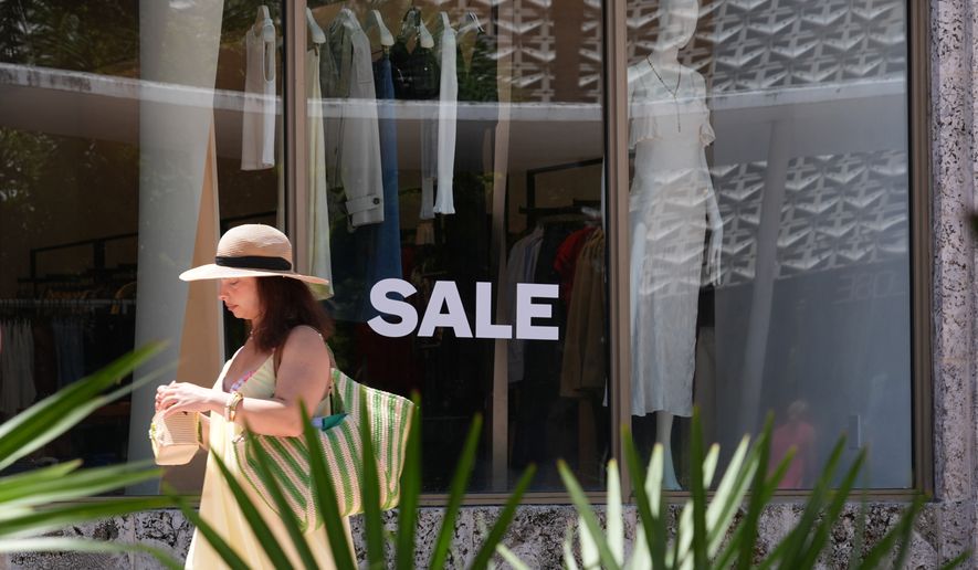 A pedestrian walks past a clothing store with items on sale Thursday, Sept. 3, 2026, in Miami Beach, Fla. (AP Photo/Marta Lavandier)