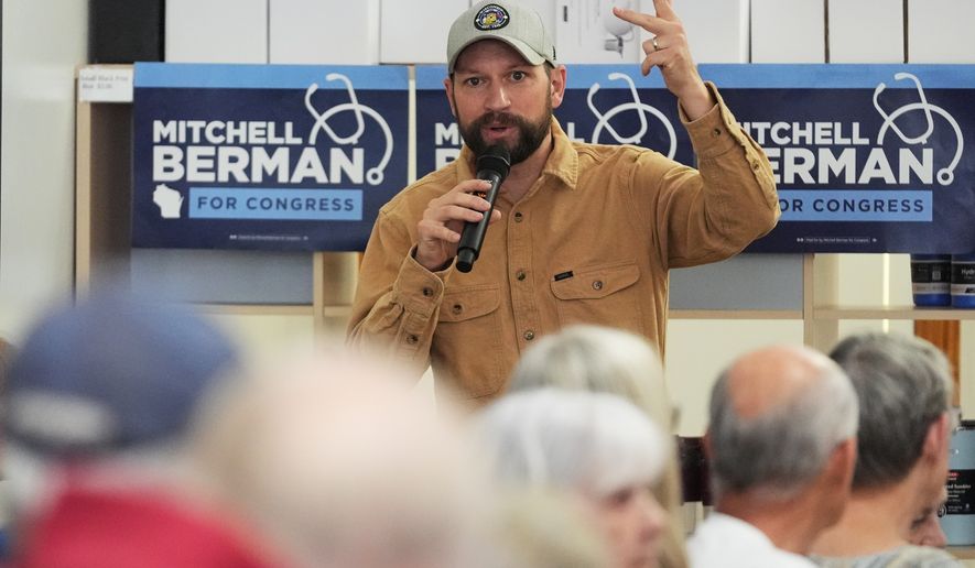 Democratic congressional candidate Mitchell Berman talks to supporters at Wilson's Coffee and Tea in Racine, Wis., Tuesday, Sept. 22, 2026.(AP Photo/Nam Y. Huh)