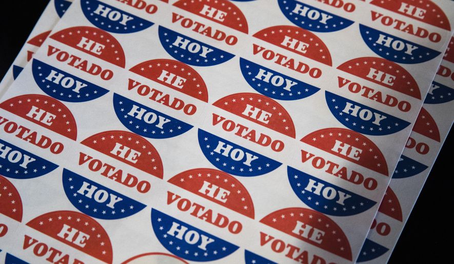 Spanish-language voting stickers that read "He Votado Hoy" ("I Voted Today") are offered at a polling place in Philadelphia on May 21, 2019. (AP Photo/Matt Rourke) **FILE**