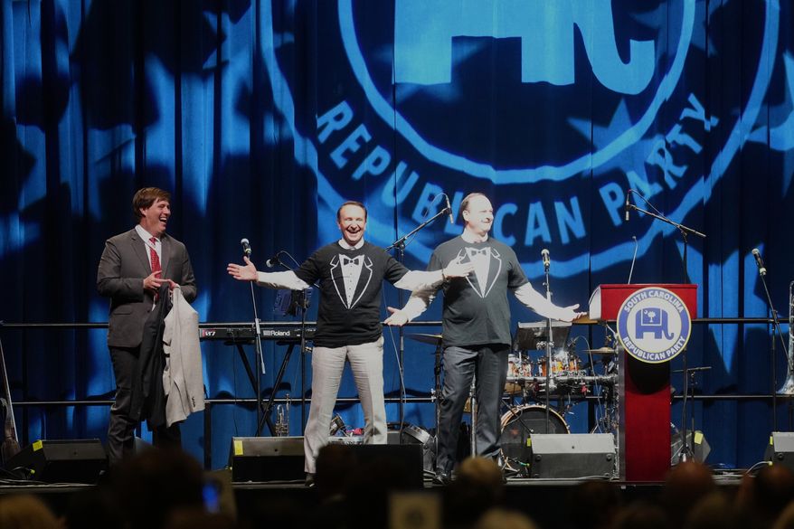 From left, Adam Piper of the Republican Attorneys General Association, Gov. Jeff Landry, R-S.C., and Attorney General Alan Wilson, R-S.C., appear on stage at the South Carolina Republican Party's Silver Elephant Gala on Saturday, Aug. 15, 2026, in Columbia, S.C. (AP Photo/Meg Kinnard)