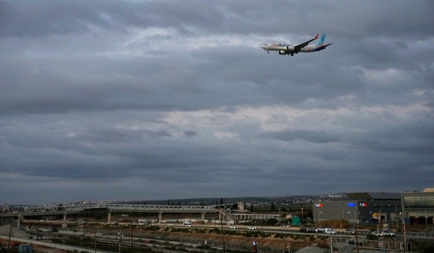An FlyDubai plane carrying Israeli passengers who had earlier been aboard another FlyDubai aircraft that made an emergency landing in Saudi Arabia approaches Ben Gurion International Airport near Tel Aviv, Israel, Wednesday, Sept. 30, 2026. (AP Photo/Ohad Zwigenberg)