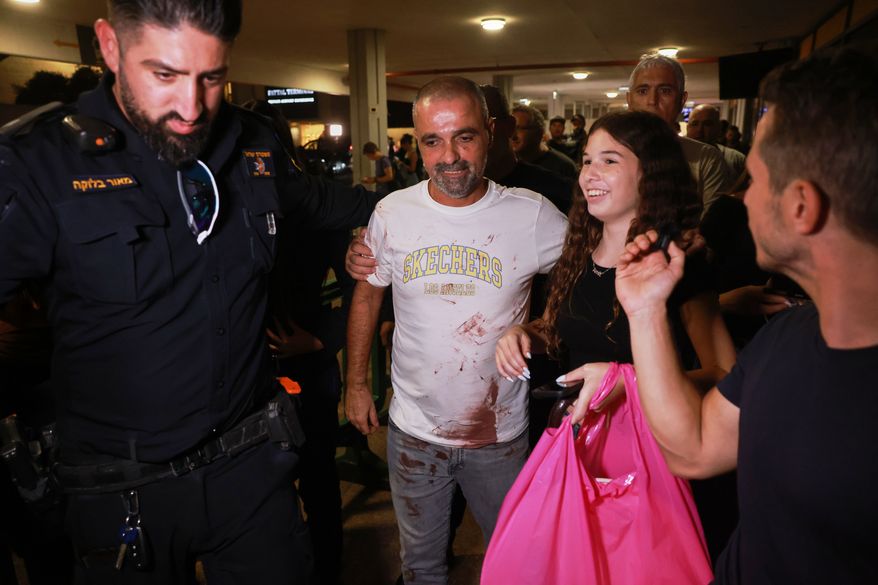 Israeli passenger Yaniv Hayoun, with blood stains on his shirt, who was aboard a Flydubai aircraft that made an emergency landing in Saudi Arabia, is welcomed at the arrivals gate at Ben Gurion International Airport near Tel Aviv, Israel, Wednesday, Sept. 30, 2026. (AP Photo/Tomer Appelbaum)