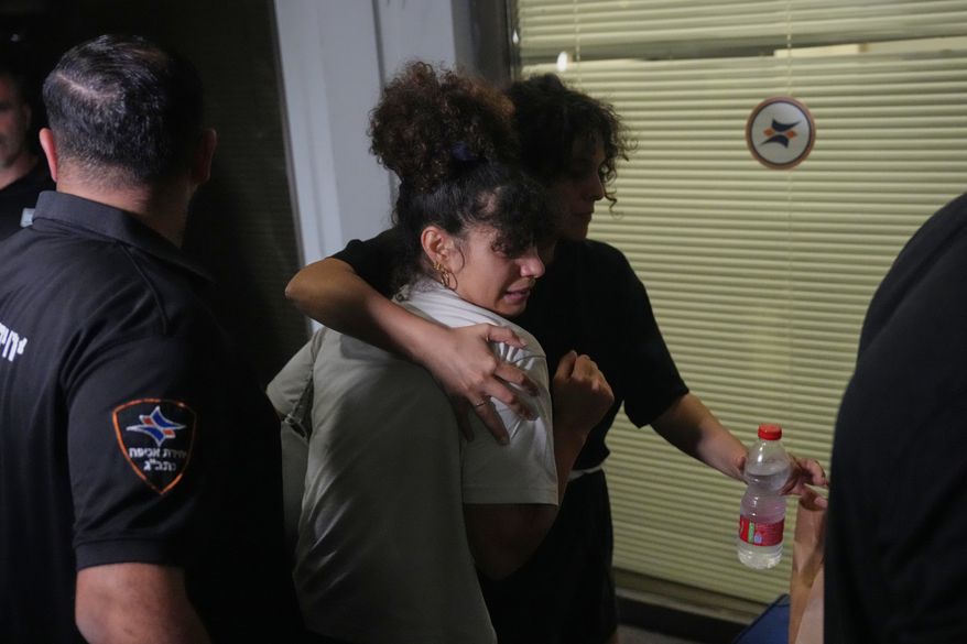 Passengers who experienced an emergency landing in Saudi Arabia, during a flight on FlyDubai plane, arrive at Ben Gurion International Airport, near Tel Aviv, Israel, Wednesday, Sept. 30, 2026. (AP Photo/Ariel Schalit)