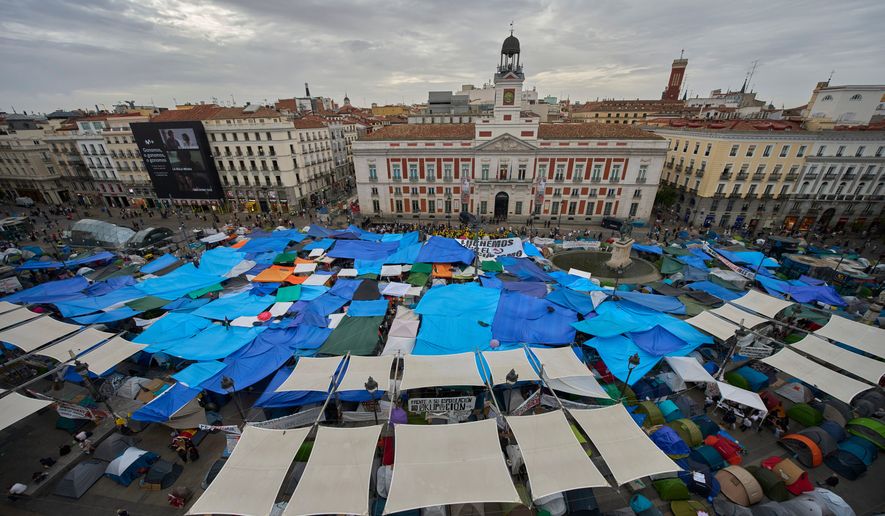 Activists camp during a protest following the eviction last Wednesday of 87-year-old Maricarmen to demand stronger laws to protect renters at Sol square in Madrid, Spain, Wednesday, Sept. 30, 2026. (AP Photo/Manu Fernandez)