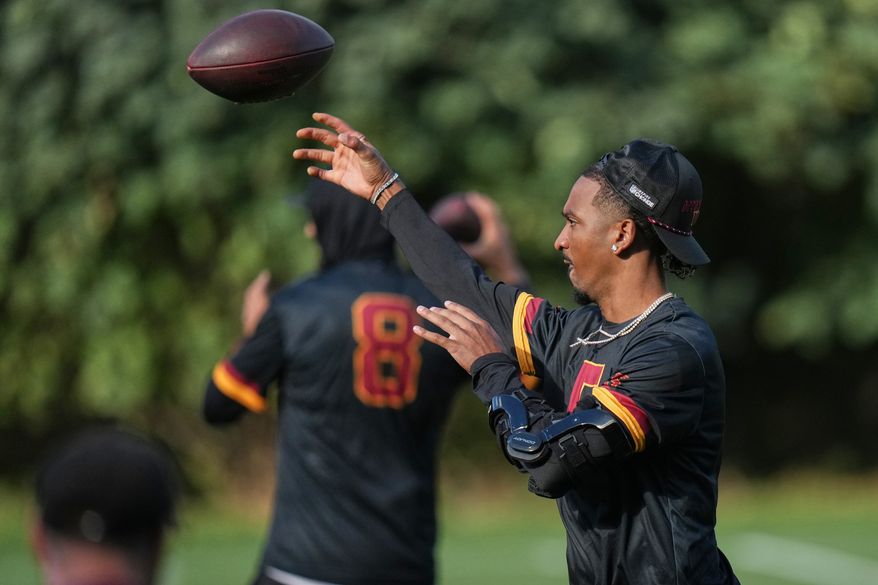 Washington Commanders quarterback Jayden Daniels (5), throws a pass during a NFL Football practice session in London, Wednesday, Sept. 30, 2026. (AP Photo/Alastair Grant)