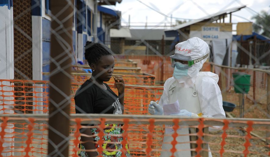 A healthcare worker speaks to Ebola patients inside a treatment center in Beni, North Kivu province, eastern Congo, Saturday, Sept. 26, 2026. (AP Photo/Sebastien Kitsa Musayi)