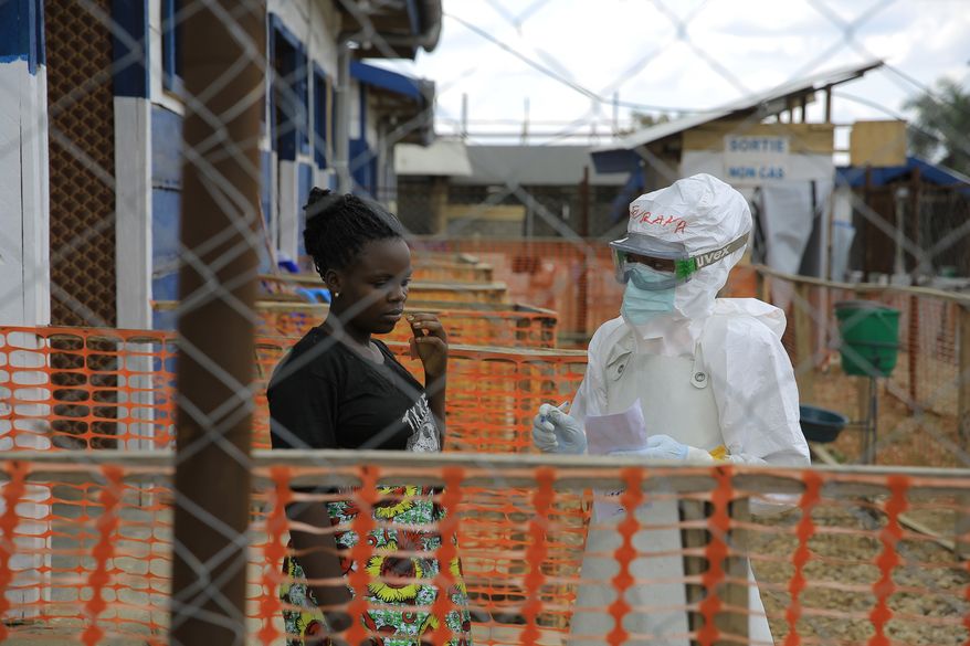A healthcare worker speaks to Ebola patients inside a treatment center in Beni, North Kivu province, eastern Congo, Saturday, Sept. 26, 2026. (AP Photo/Sebastien Kitsa Musayi)