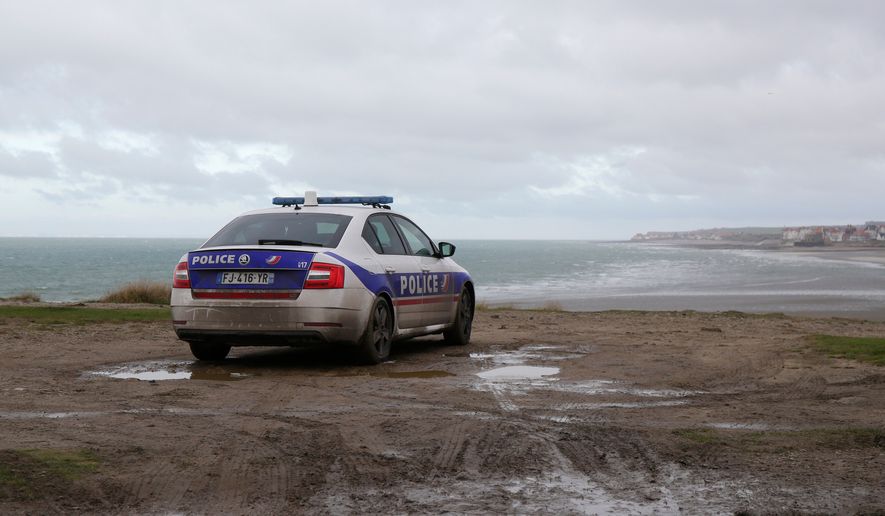FILE - A parked police car parks overlooks the shore in Wimereux, northern France, on Nov. 25, 2021. (AP Photo/Michel Spingler, File)