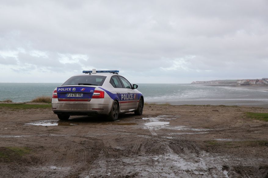 FILE - A parked police car parks overlooks the shore in Wimereux, northern France, on Nov. 25, 2021. (AP Photo/Michel Spingler, File)