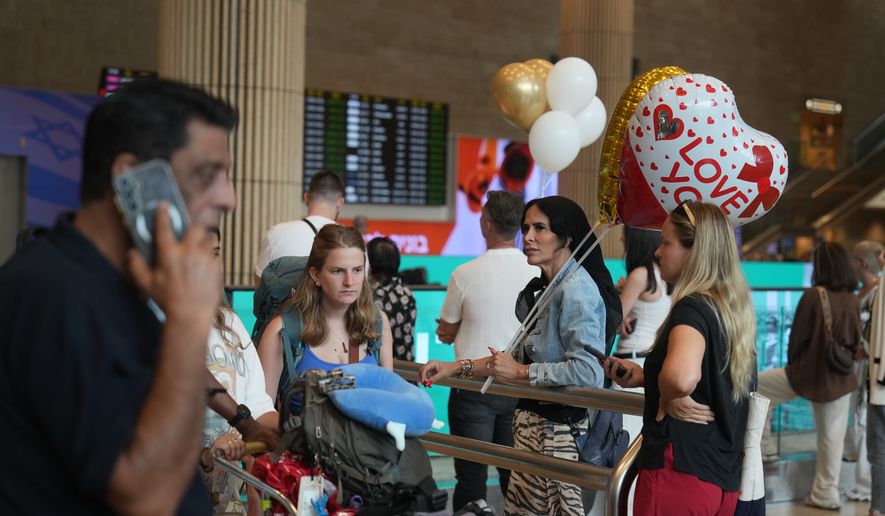 Holding balloons people wait for the arrival of passengers at Ben Gurion International Airport, near Tel Aviv, Israel, Wednesday, Sept. 30, 2026. (AP Photo/Ariel Schalit)
