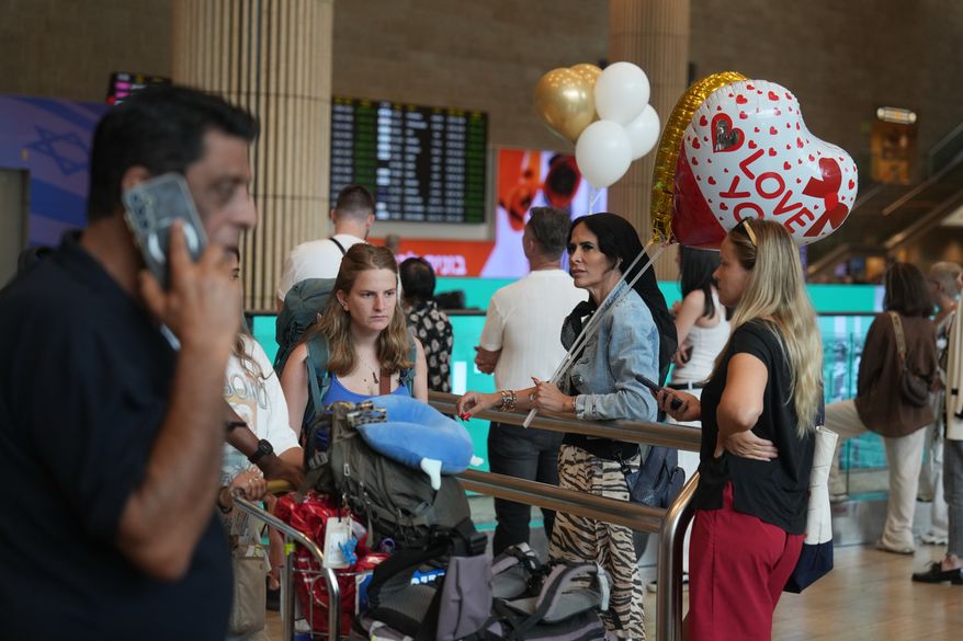 Holding balloons people wait for the arrival of passengers at Ben Gurion International Airport, near Tel Aviv, Israel, Wednesday, Sept. 30, 2026. (AP Photo/Ariel Schalit)