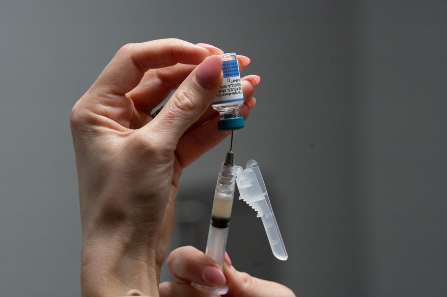 A nurse, prepares a combination measles, mumps and rubella vaccine for a patient at a pediatrics clinic in Easley, S.C., March 17, 2026. (AP Photo/Mary Conlon, File)