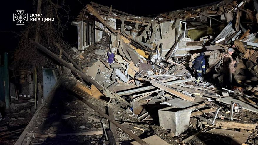In this photo provided by the Ukrainian Emergency Services on Wednesday, Sept. 30, 2026, a rescuer walks on a site of a Russian drone strike on residential house in Kyiv region, Ukraine. (Ukrainian Emergency Service via AP)