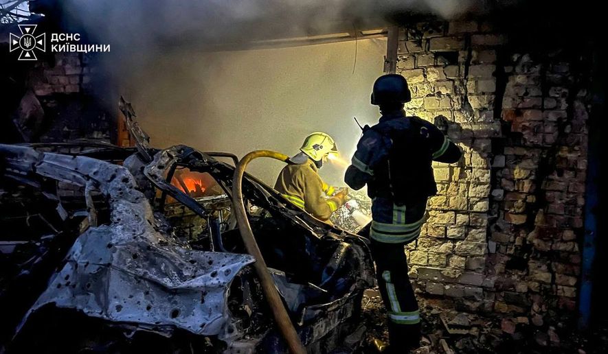 In this photo provided by the Ukrainian Emergency Services on Wednesday, Sept. 30, 2026, rescuers put out a fire in a garage destroyed after a Russian drone strike on Kyiv region, Ukraine. (Ukrainian Emergency Service via AP)