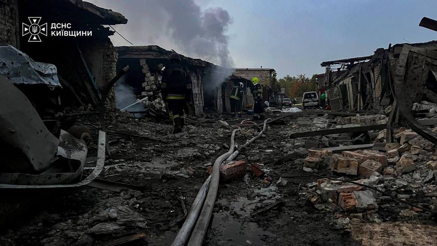 In this photo provided by the Ukrainian Emergency Services on Wednesday, Sept. 30, 2026, rescuers put out a fire affecting garages destroyed after a Russian drone strike on Kyiv region, Ukraine. (Ukrainian Emergency Service via AP)