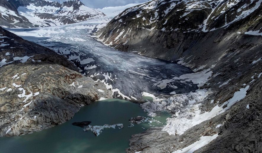 A lake of meltwater has formed on the tongue of the Rhone glacier near Goms, Switzerland, June 13, 2023. (AP Photo/Matthias Schrader, File)