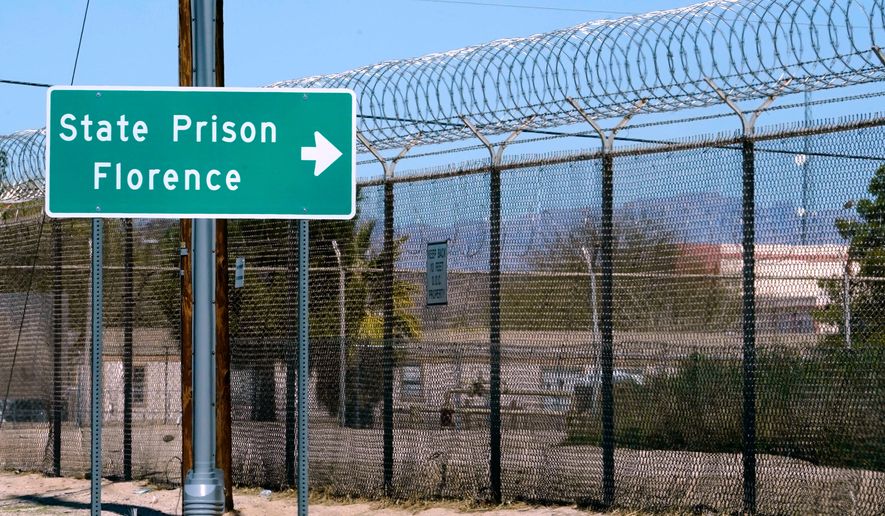 A sign points in the direction of the Arizona State Prison in Florence, Ariz., March 19, 2025. (AP Photo/Darryl Webb, File)