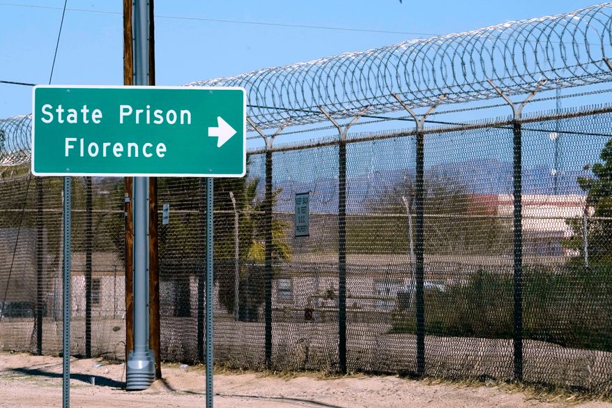 A sign points in the direction of the Arizona State Prison in Florence, Ariz., March 19, 2025. (AP Photo/Darryl Webb, File)