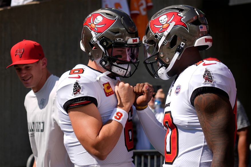 Tampa Bay Buccaneers quarterbacks Baker Mayfield (6) and Jalon Daniels (10) enter the field to warm up before an NFL football game against the Cincinnati Bengals Sunday, Sept. 13, 2026, in Cincinnati. (AP Photo/Carolyn Kaster)